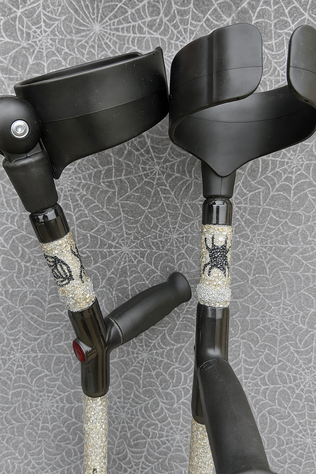 Rhinestone embellished crutches with a spider design black handles 